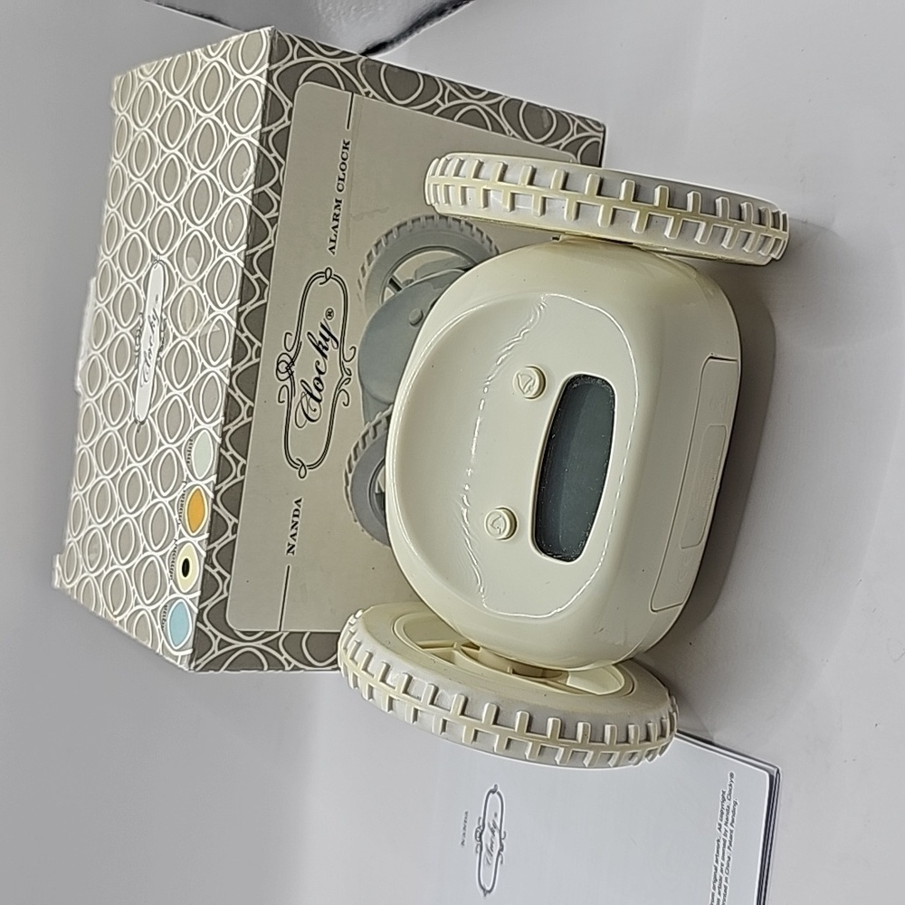 Clocky alarm on set of wheels rolls around gets child out of bed to shut off